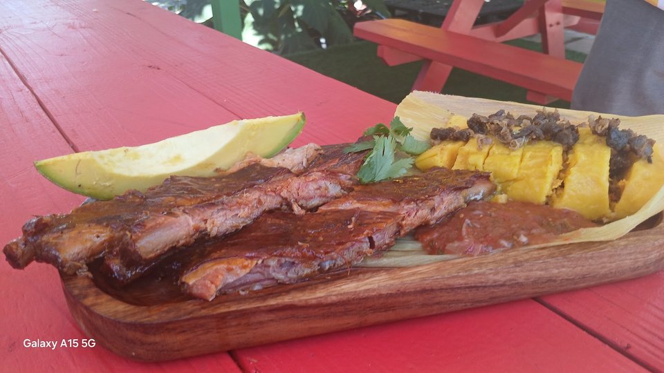 A family-style meal with smoked barbecue and sides.